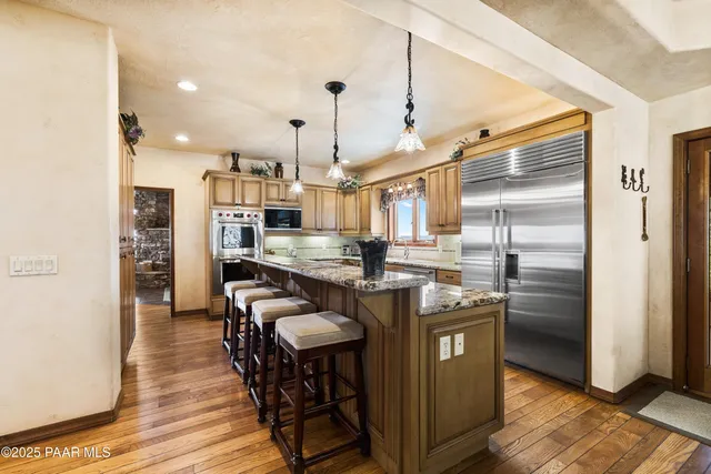 a view of a lush green forest with a mountain