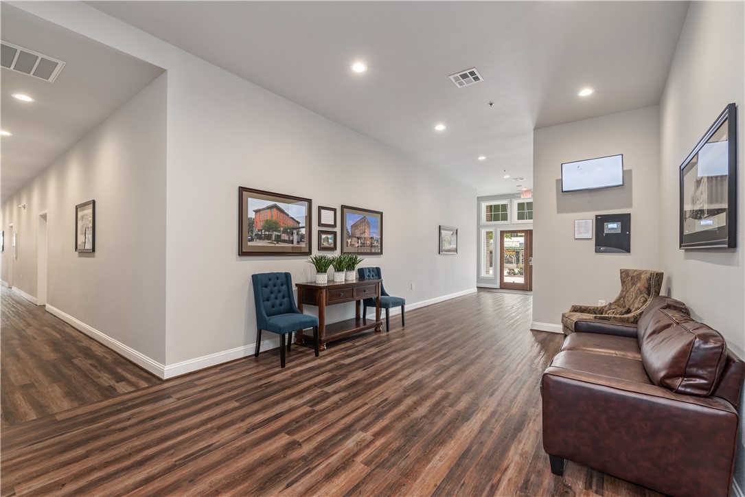 401 North Main Street, Unit 206 Bryan, TX 77803 - Photo 17 of 20 a living room with furniture and a wooden floor