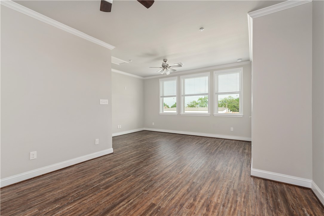 401 North Main Street, Unit 206 Bryan, TX 77803 - Photo 8 of 20 an empty room with wooden floor and windows