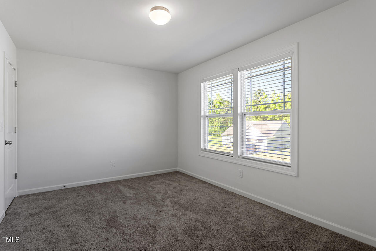 147 Pineapple Place Benson, NC 27504 - Photo 14 of 20 an empty room with a window
