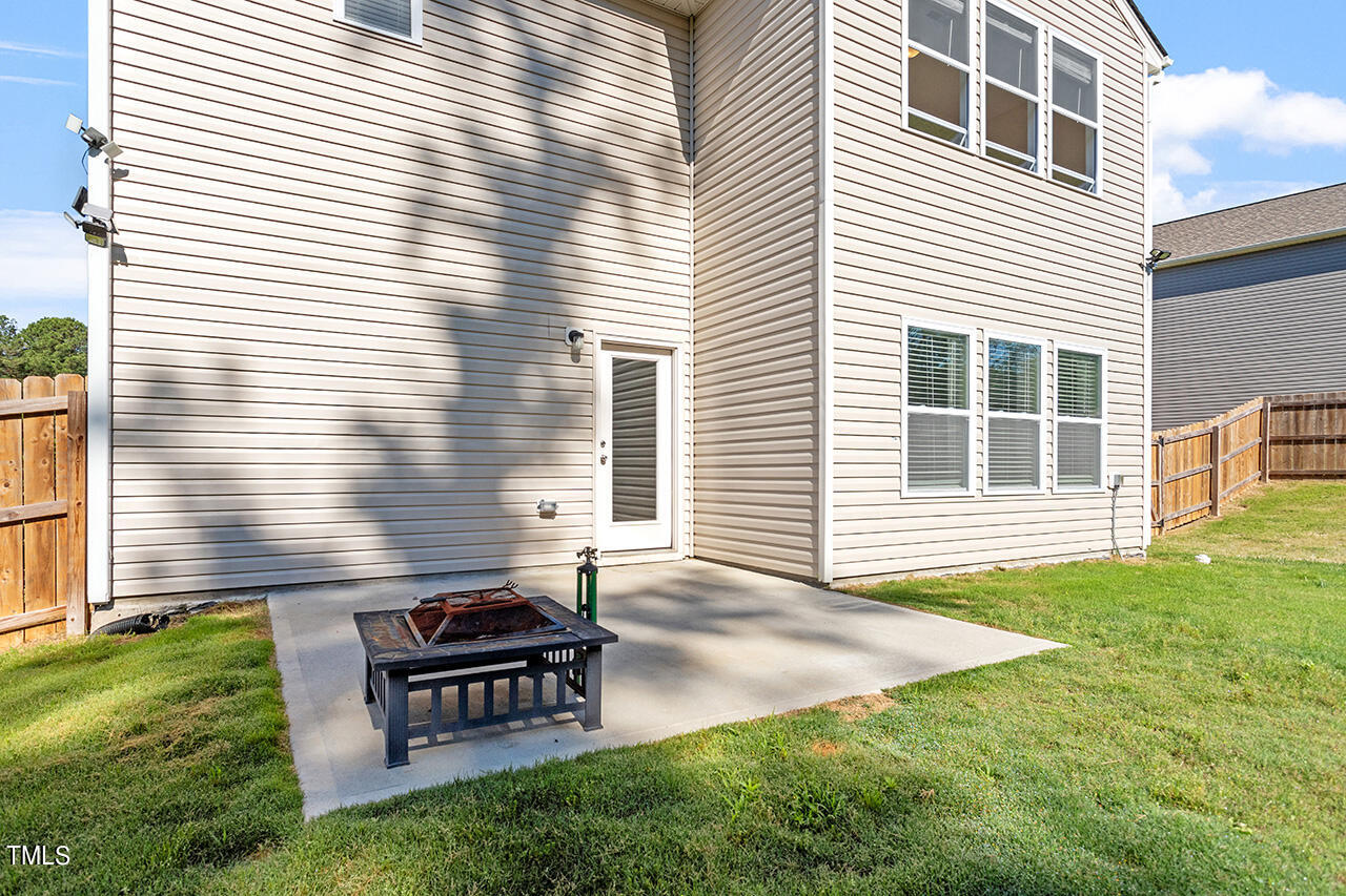 147 Pineapple Place Benson, NC 27504 - Photo 18 of 20 a backyard of a house with a garden