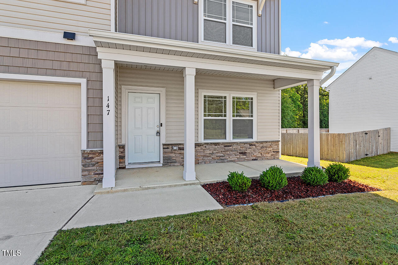 147 Pineapple Place Benson, NC 27504 - Photo 2 of 20 a front view of a house with garden