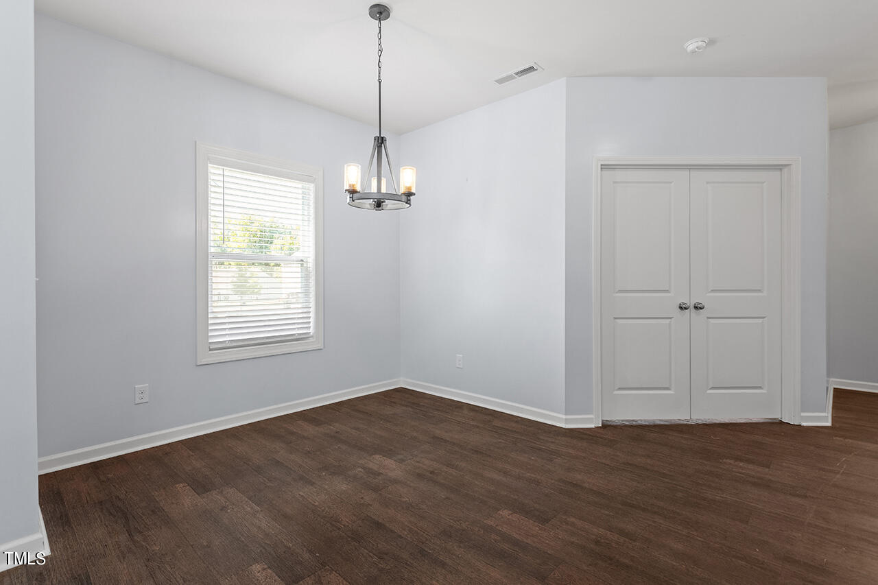 147 Pineapple Place Benson, NC 27504 - Photo 5 of 20 a view of empty room with wooden floor and window