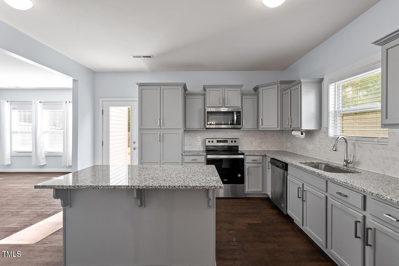 147 Pineapple Place Benson, NC 27504 - Photo 9 of 20 a kitchen with sink a microwave and cabinets