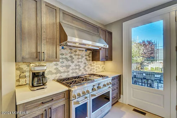 a bathroom with a granite countertop sink a mirror and a shower