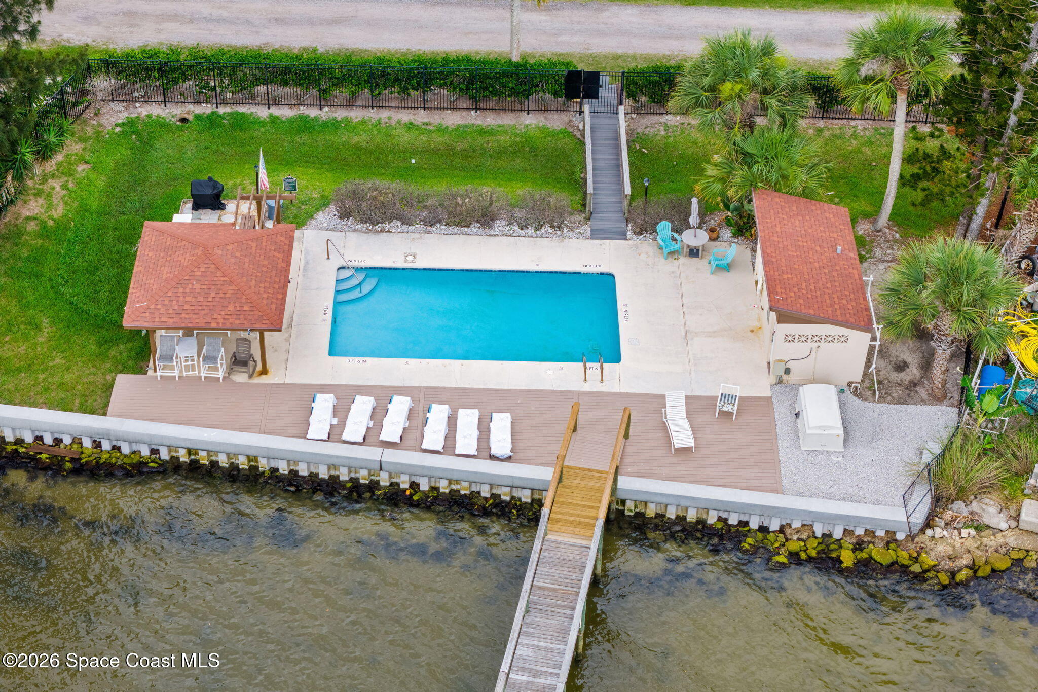 3121 Kirkland Road Northeast Palm Bay, FL 32905 - Photo 38 of 52 a view of a house with pool and a yard