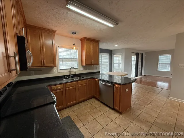 a kitchen with stainless steel appliances a refrigerator and a stove