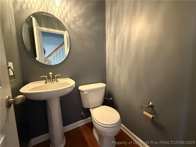 an empty room with windows and chandelier fan