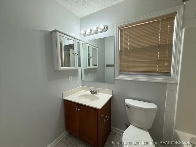 a bathroom with a tub a sink and a shower