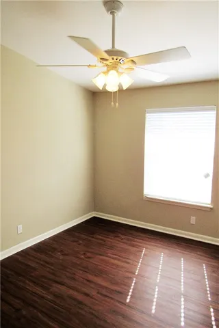 a view of a room with wooden floor and fan