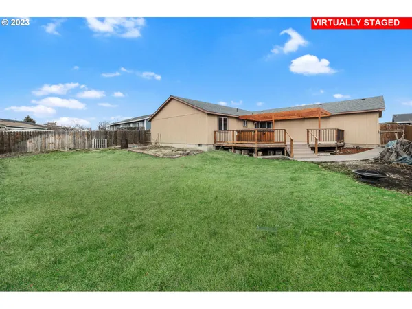 a view of a house with a big yard and potted plants