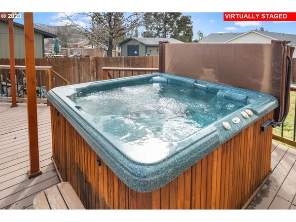 a living room with furniture a window and a flat screen tv