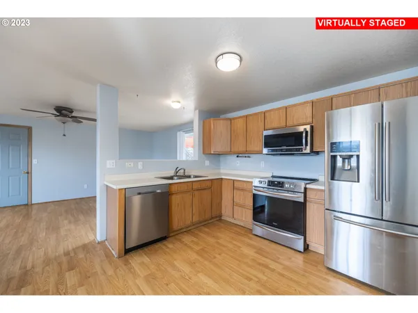 a kitchen with stainless steel appliances granite countertop a sink and a stove