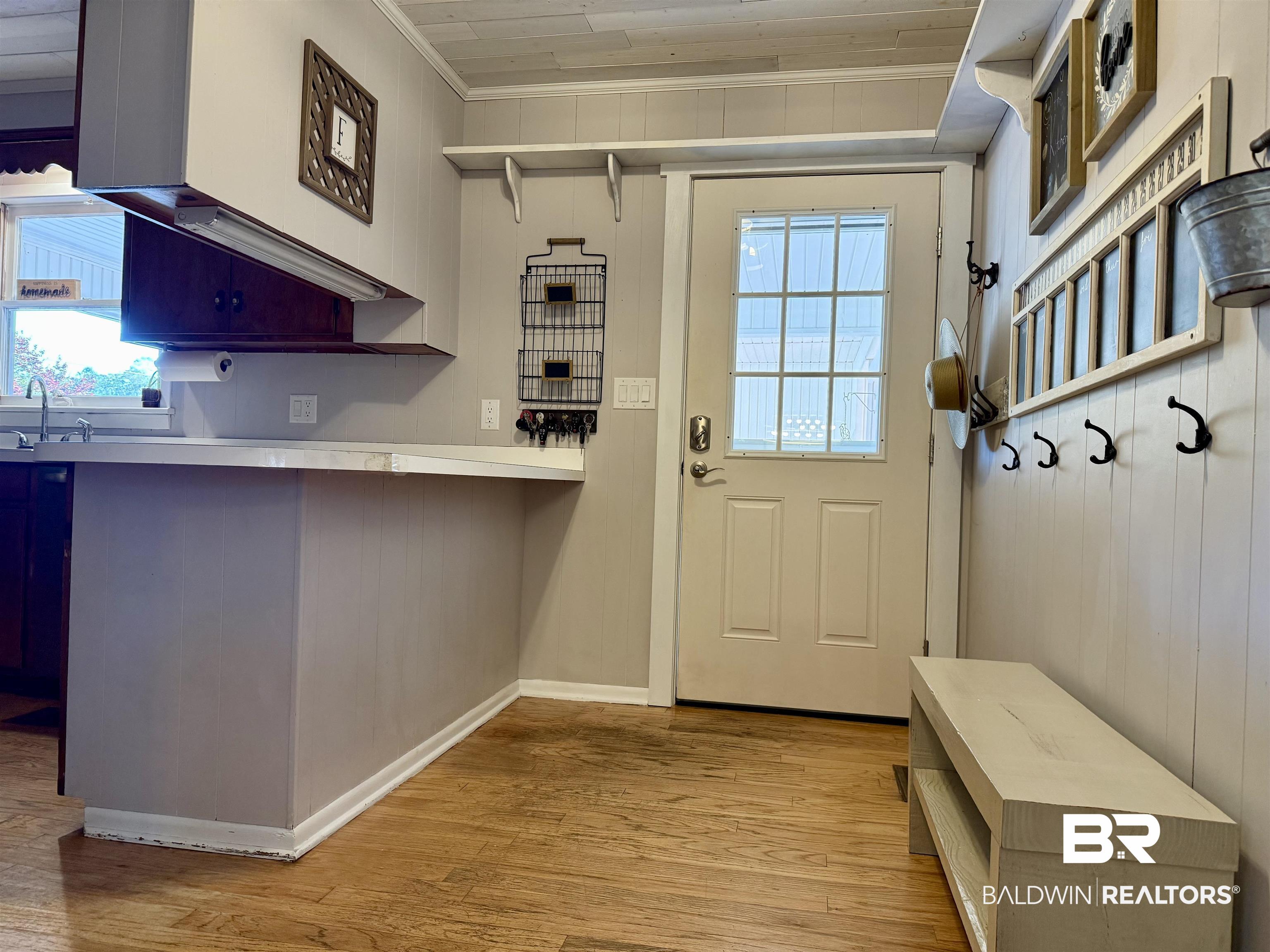 2785 Appleton Road Brewton, AL 36426 - Photo 9 of 28 Mudroom with light wood finished floors, wooden walls, and crown molding