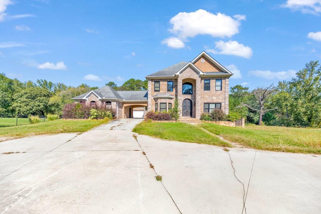 193 Stanley Road Fayetteville, GA 30214 - Photo 1 of 1 a front view of a house with a yard and garage