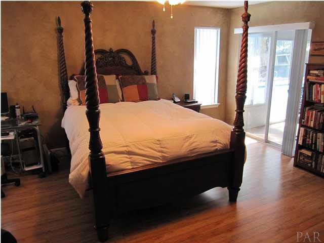 3077 Red Fern Road Cantonment, FL 32533 - Photo 13 of 25 Master bedroom. Sliding glass door opens to the sunroom.