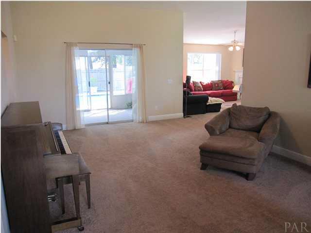 3077 Red Fern Road Cantonment, FL 32533 - Photo 3 of 25 View of living room from hallway leading to additional bedrooms & baths. Sliding doors open to the sunroom.