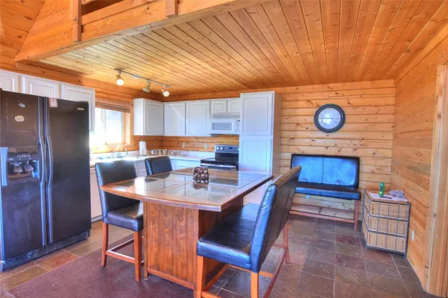a kitchen with stainless steel appliances granite countertop a sink a stove and cabinets
