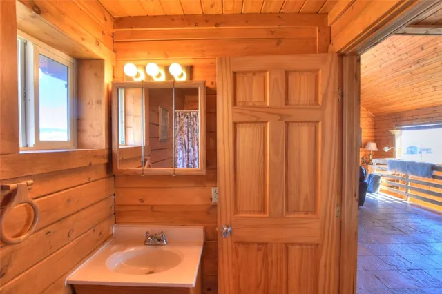 a bathroom with a toilet and a shower curtain