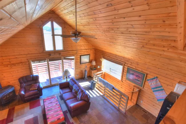 a living room with furniture wooden floor and a flat screen tv