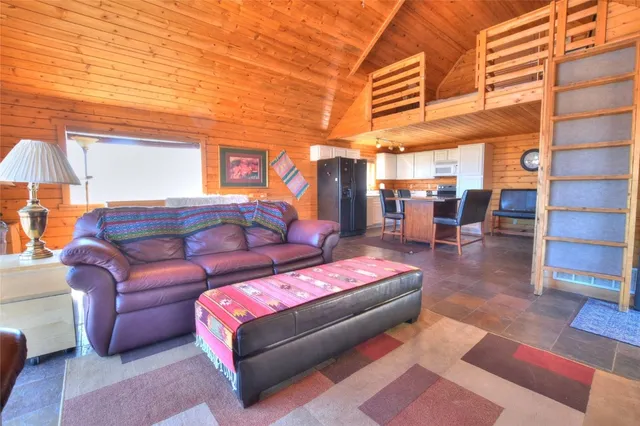 a view of a patio with couches and kitchen view