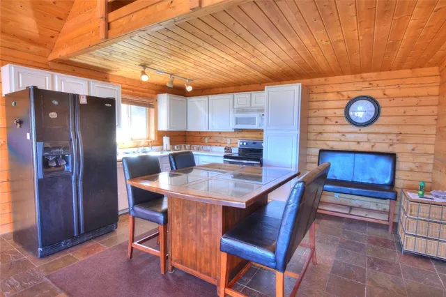 a kitchen with a wooden table and chairs