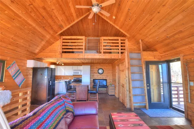 a outdoor living with furniture a ceiling fan and a wooden floor