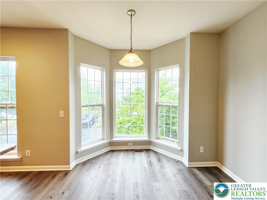 8513 Gateway Road Breinigsville, PA 18031 - Photo 21 of 45 A charming dining area features bay windows and warm wood flooring.