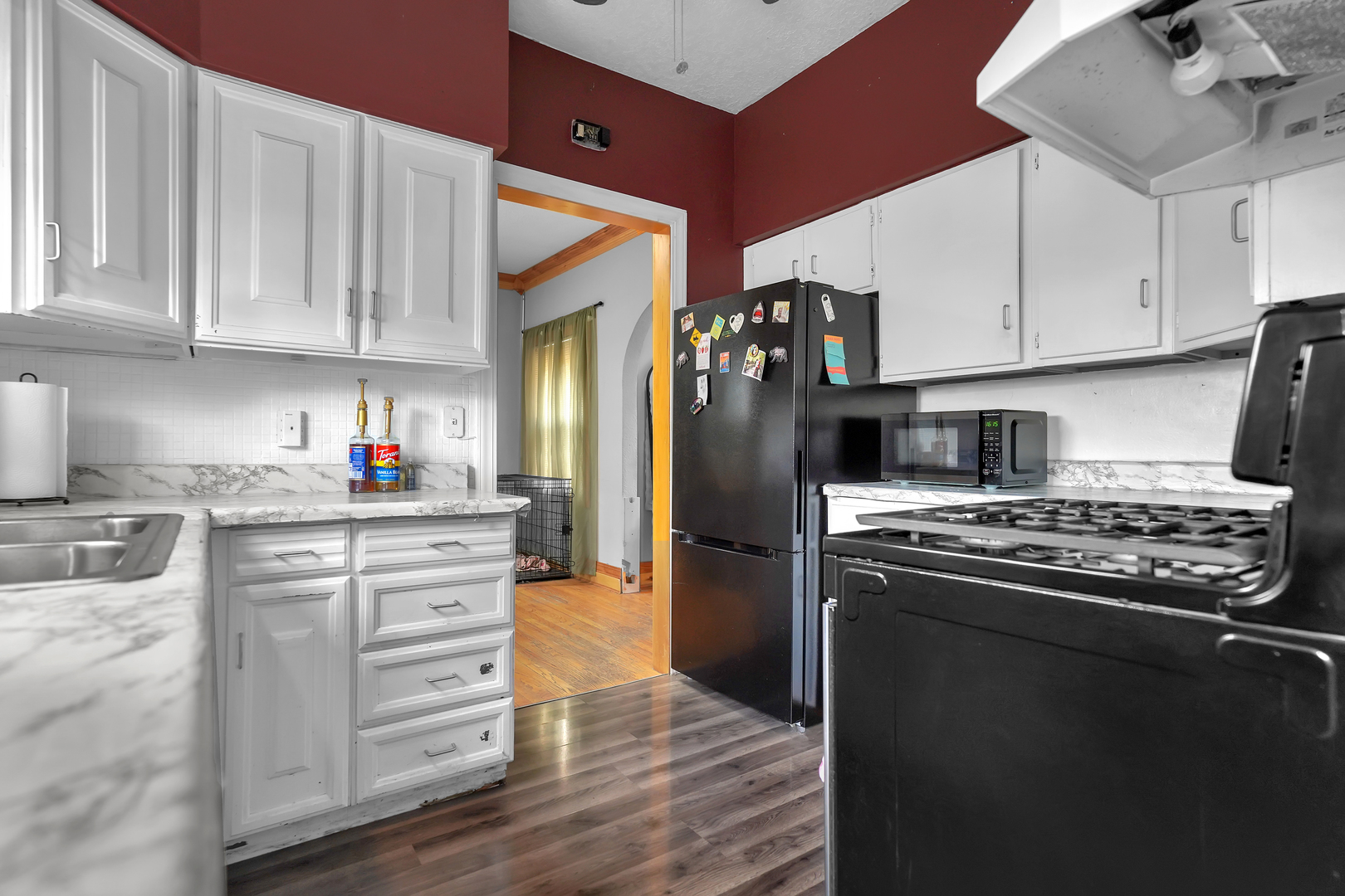 1134 South Myrtle Avenue Kankakee, IL 60901 - Photo 13 of 32 a kitchen with granite countertop a refrigerator stove top oven and cabinets