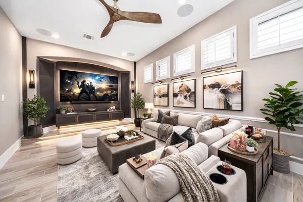 a living room with furniture a flat screen tv and a large window