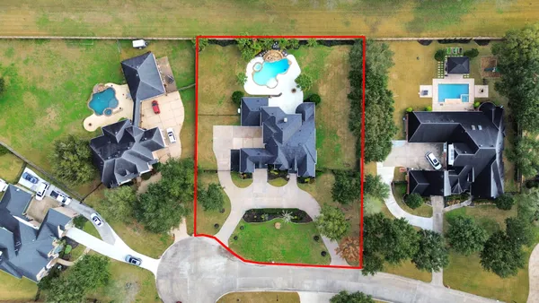 an aerial view of a house with outdoor space swimming pool