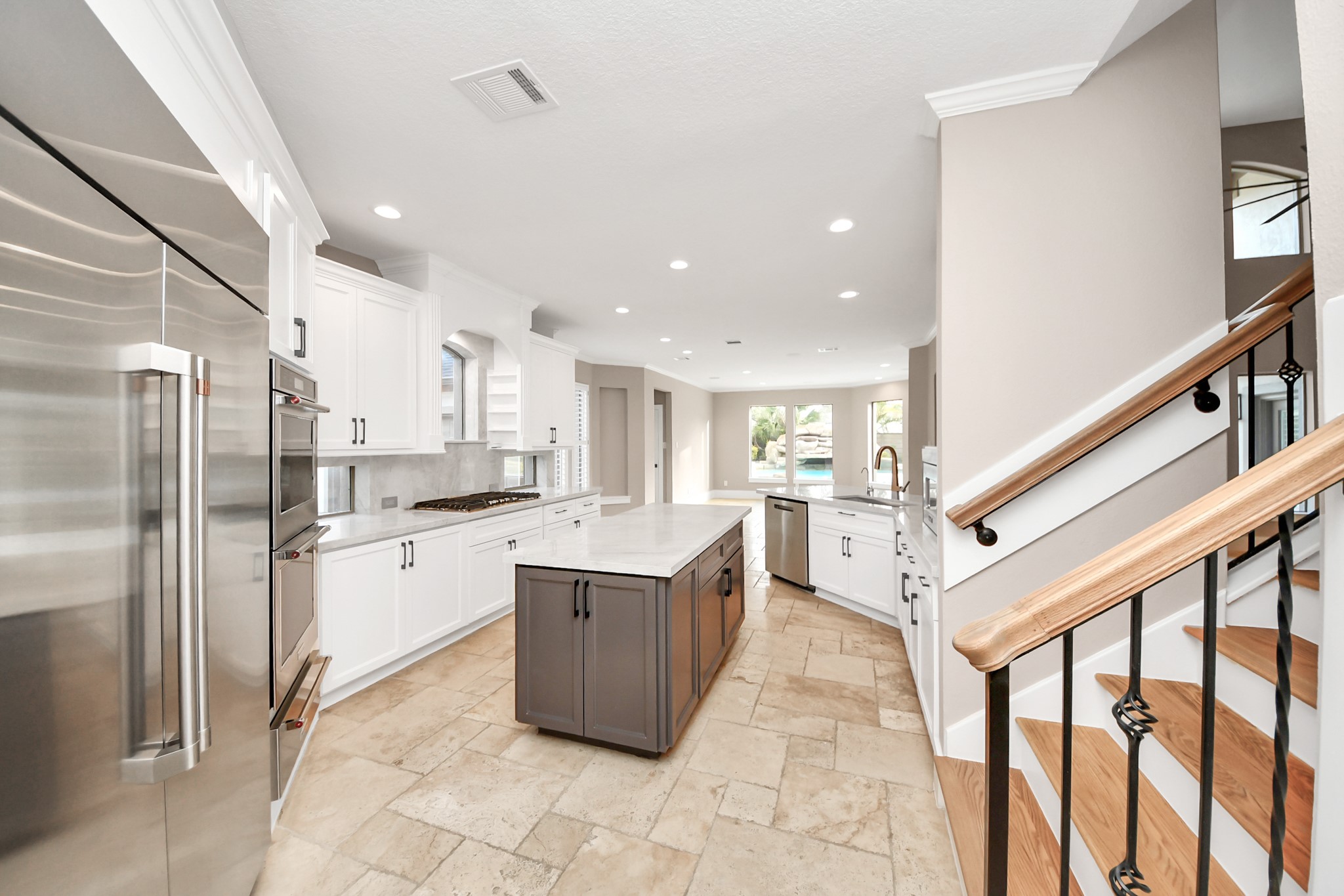 2211 Braer Ridge Drive Katy, TX 77494 - Photo 32 of 50 a kitchen with stainless steel appliances kitchen island granite countertop a refrigerator and a sink