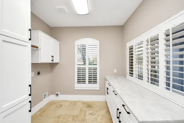 an empty room with fireplace and windows