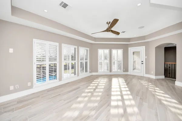 a view of a livingroom with a ceiling fan and window