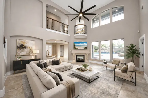 a living room with furniture fireplace and a large window