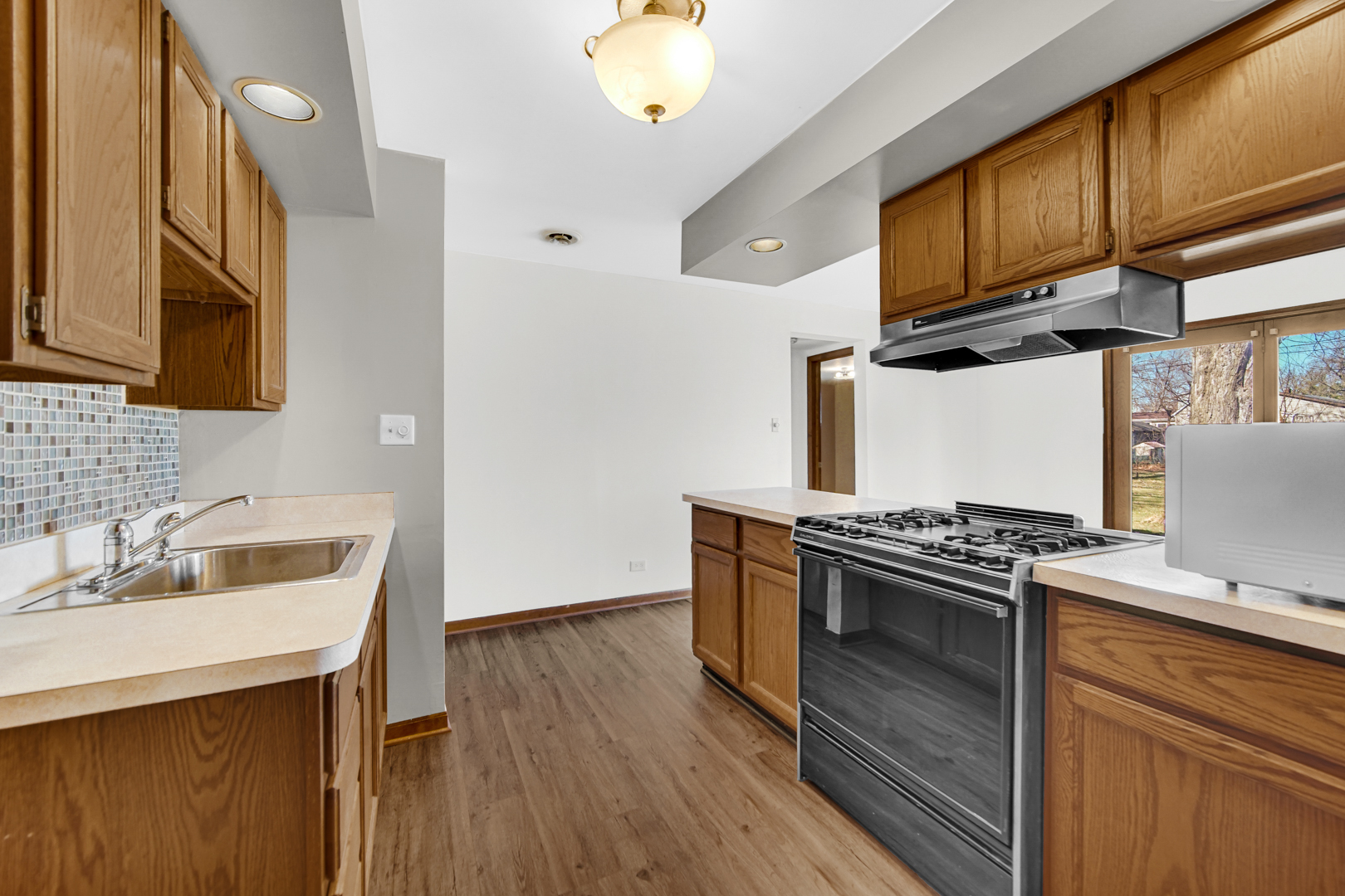 1634 Burr Oak Road Homewood, IL 60430 - Photo 17 of 36 a kitchen with granite countertop a stove and a sink