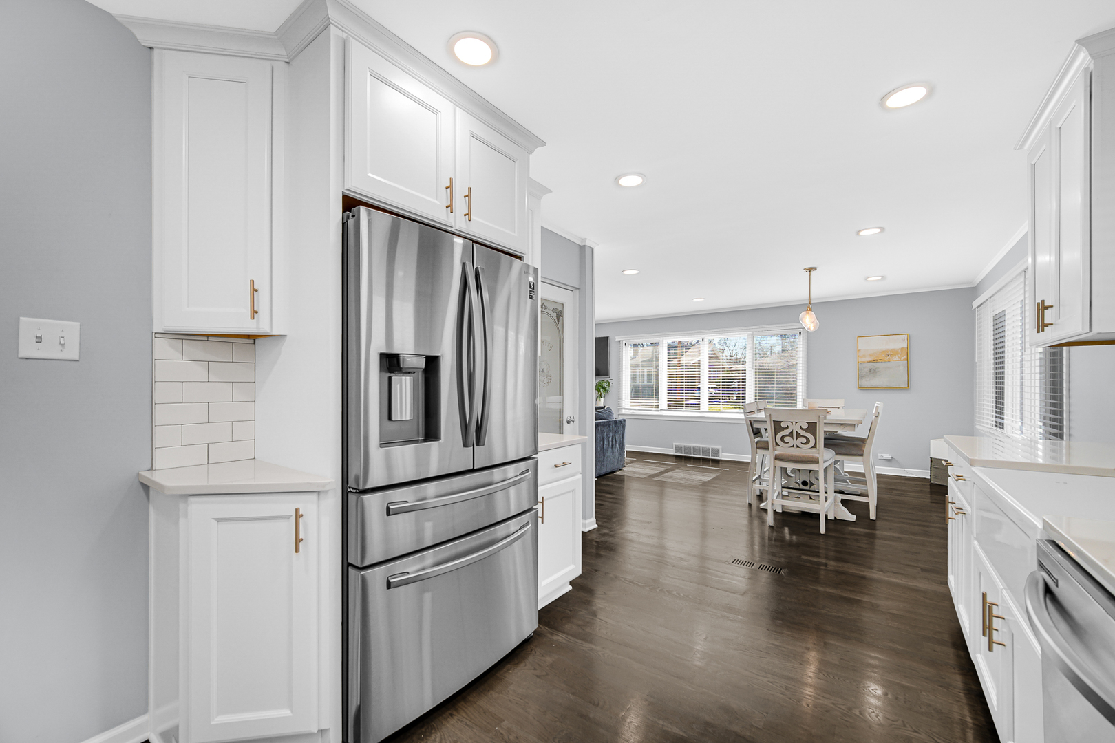 1634 Burr Oak Road Homewood, IL 60430 - Photo 4 of 36 a kitchen with stainless steel appliances a refrigerator a stove a dining table and chairs with wooden floor
