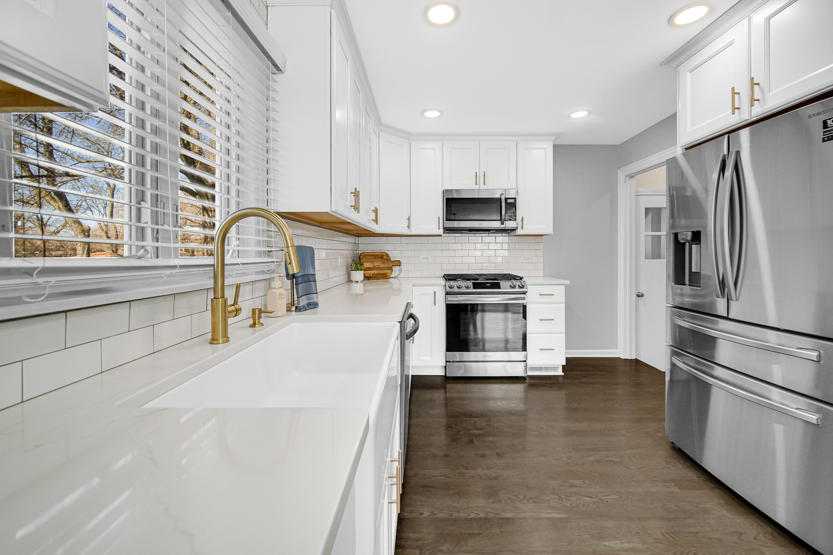 1634 Burr Oak Road Homewood, IL 60430 - Photo 5 of 36 a kitchen with stainless steel appliances a stove a sink a refrigerator white cabinets and wooden floor