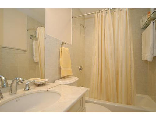 64 Tanglewood Road, Unit 64 Newton, MA 02459 - Photo 8 of 10 a bathroom with a sink a mirror and a shower
