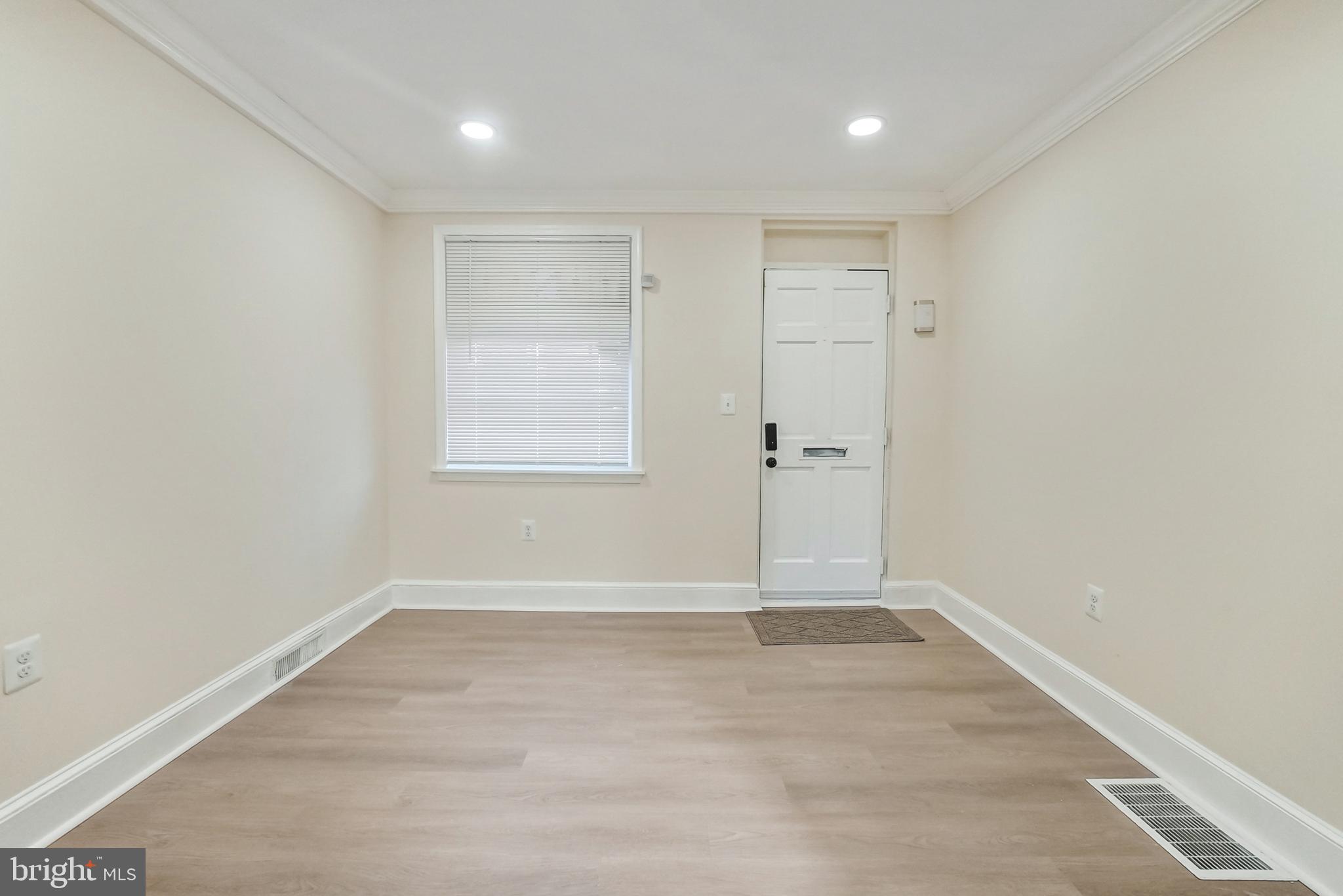 2725 Hudson Street Baltimore, MD 21224 - Photo 24 of 66 an empty room with wooden floor and window