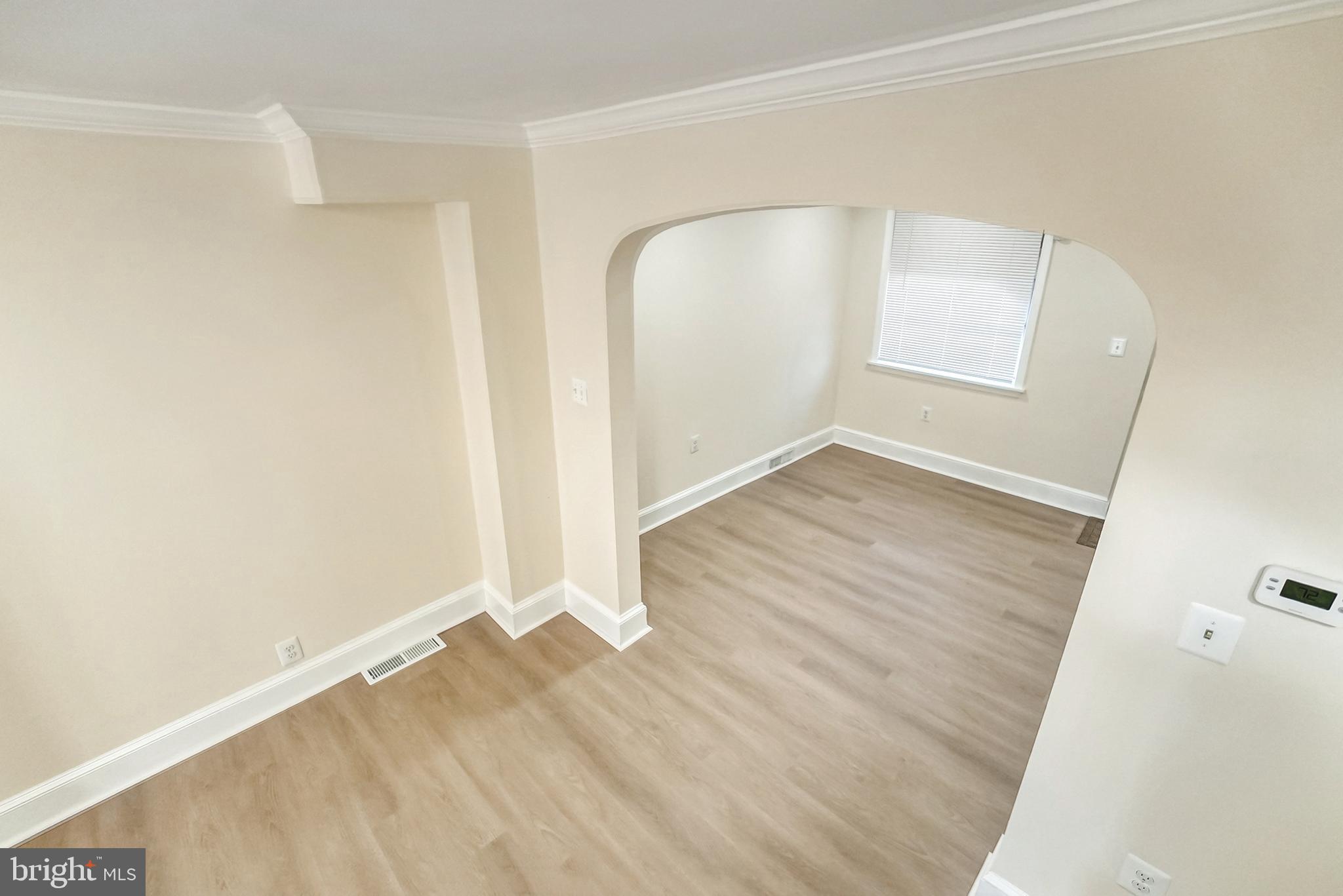 2725 Hudson Street Baltimore, MD 21224 - Photo 25 of 66 an empty room with wooden floor and sliding door