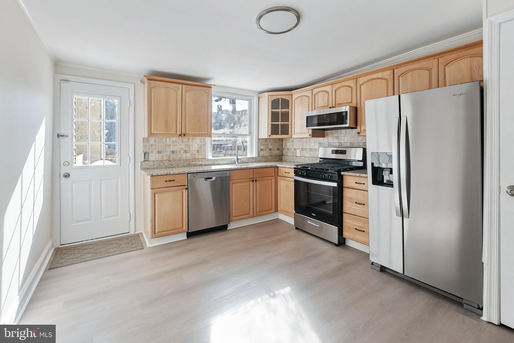 2725 Hudson Street Baltimore, MD 21224 - Photo 26 of 66 a kitchen with stainless steel appliances granite countertop a refrigerator stove and sink
