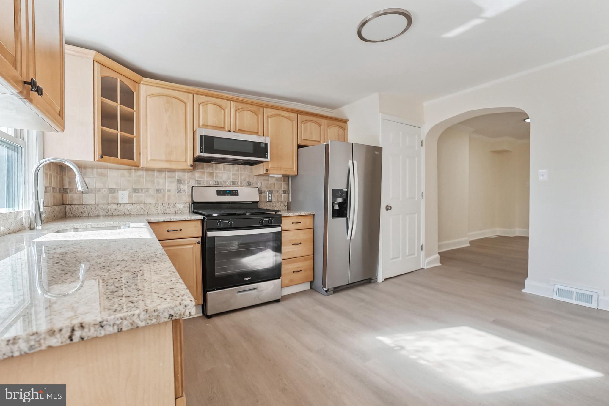 2725 Hudson Street Baltimore, MD 21224 - Photo 28 of 66 a kitchen with granite countertop a refrigerator and a sink