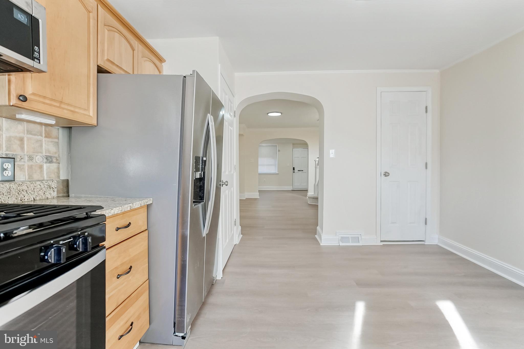 2725 Hudson Street Baltimore, MD 21224 - Photo 31 of 66 a kitchen with stainless steel appliances granite countertop a refrigerator and a stove