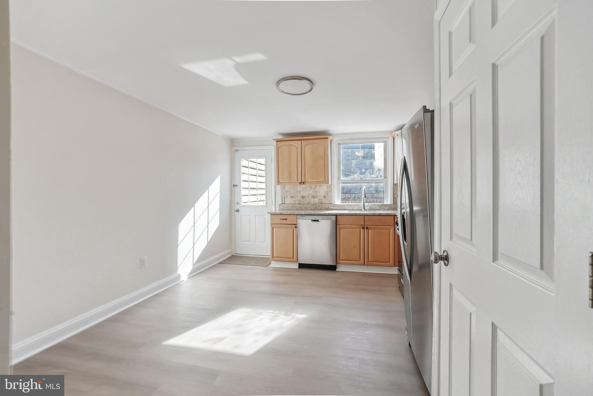 2725 Hudson Street Baltimore, MD 21224 - Photo 32 of 66 a large white kitchen with a sink and cabinets