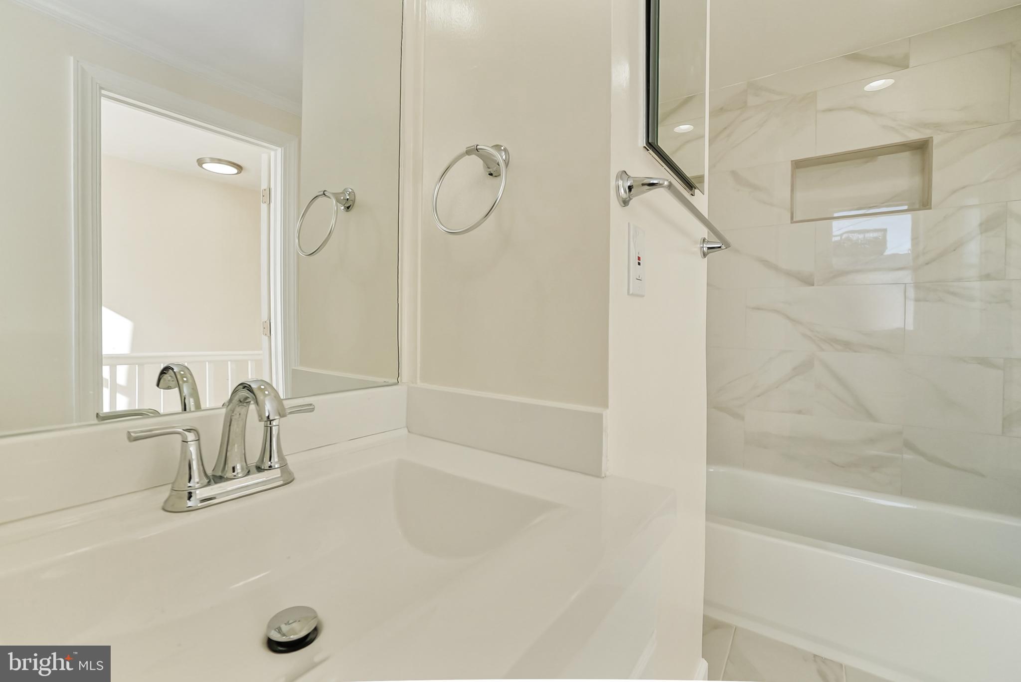 2725 Hudson Street Baltimore, MD 21224 - Photo 42 of 66 a bathroom with a tub sink shower and mirror