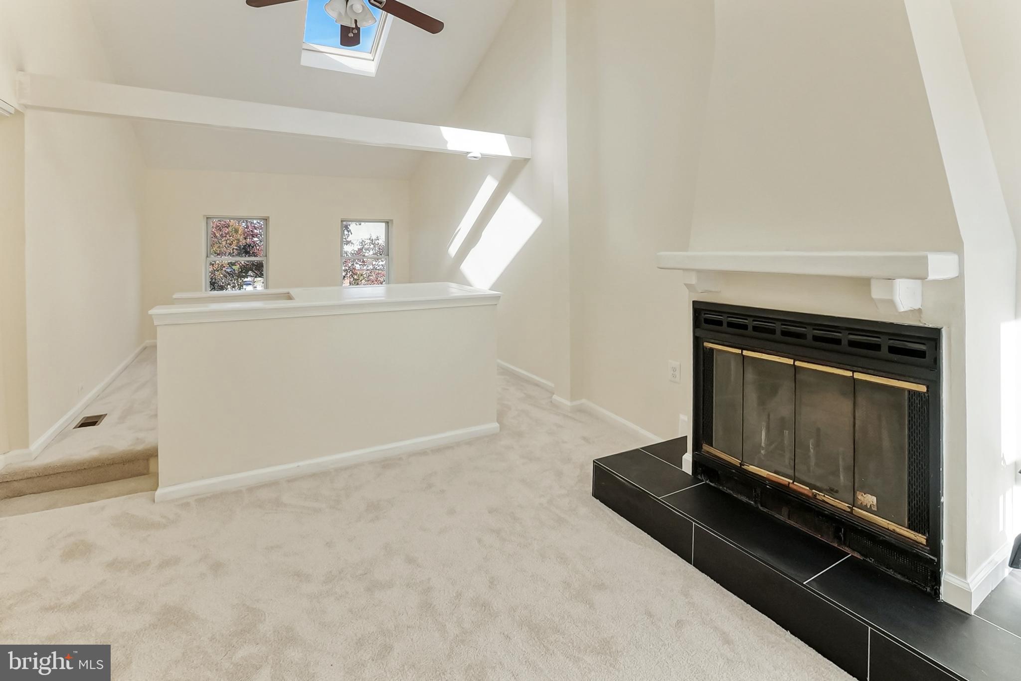 2725 Hudson Street Baltimore, MD 21224 - Photo 49 of 66 a living room with a fireplace furniture and a ceiling fan