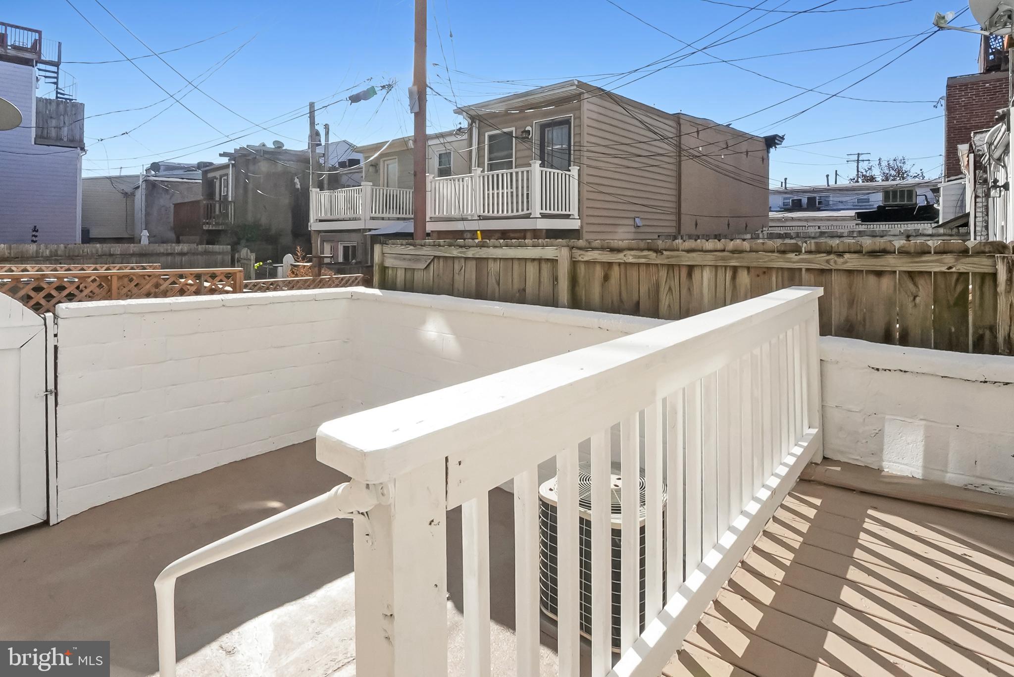 2725 Hudson Street Baltimore, MD 21224 - Photo 66 of 66 a view of roof deck with wooden floor and fence