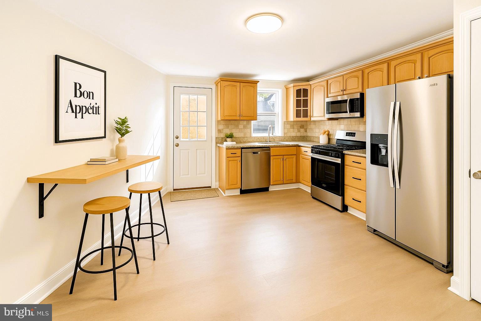 2725 Hudson Street Baltimore, MD 21224 - Photo 10 of 66 a kitchen with stainless steel appliances granite countertop a refrigerator and a stove top oven