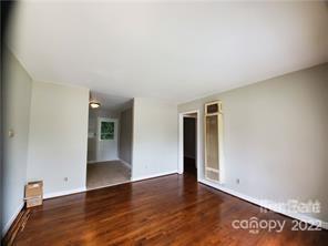 3838 Tuckaseegee Road Charlotte, NC 28208 - Photo 3 of 9 an empty room with wooden floor and closet